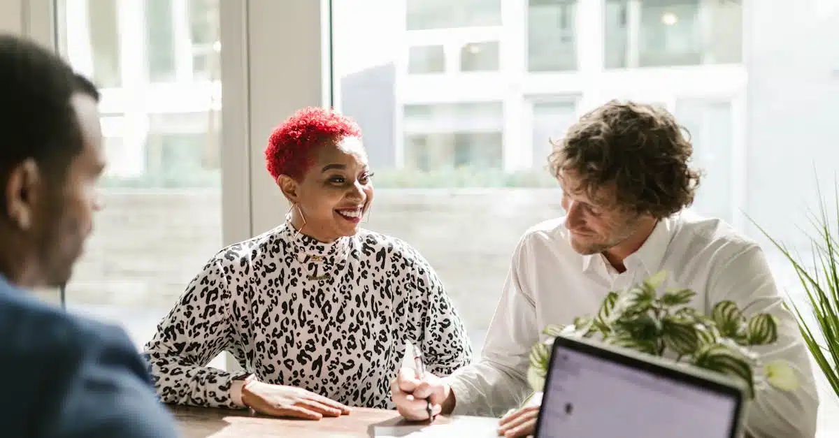 Man in Black and White Long Sleeve Shirt Sitting Beside Woman in White Long Sleeve Shirt